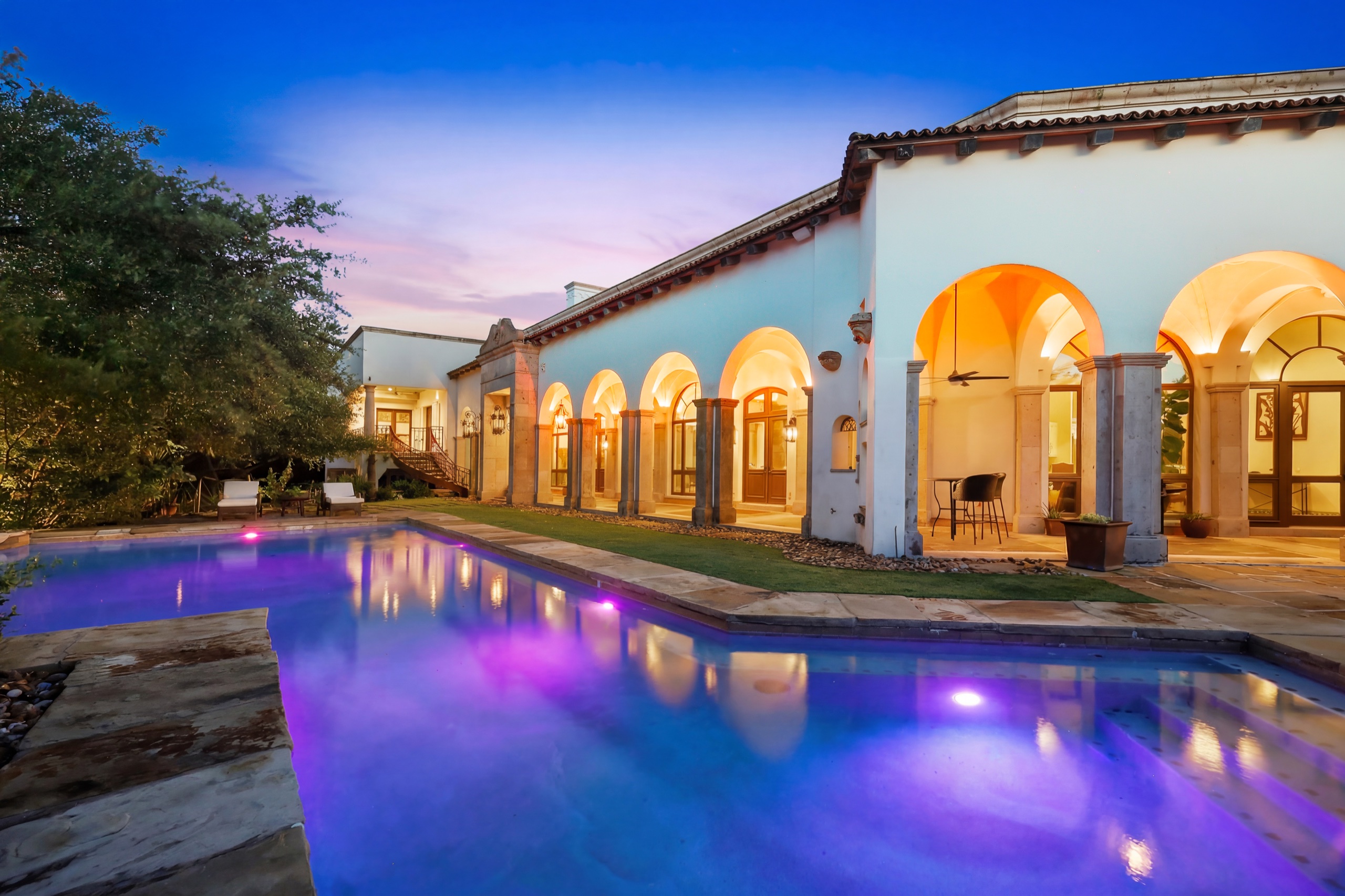 Purple-lit pool and Spanish-style exterior at 1726 Greystone Ridge in San Antonio, Texas
