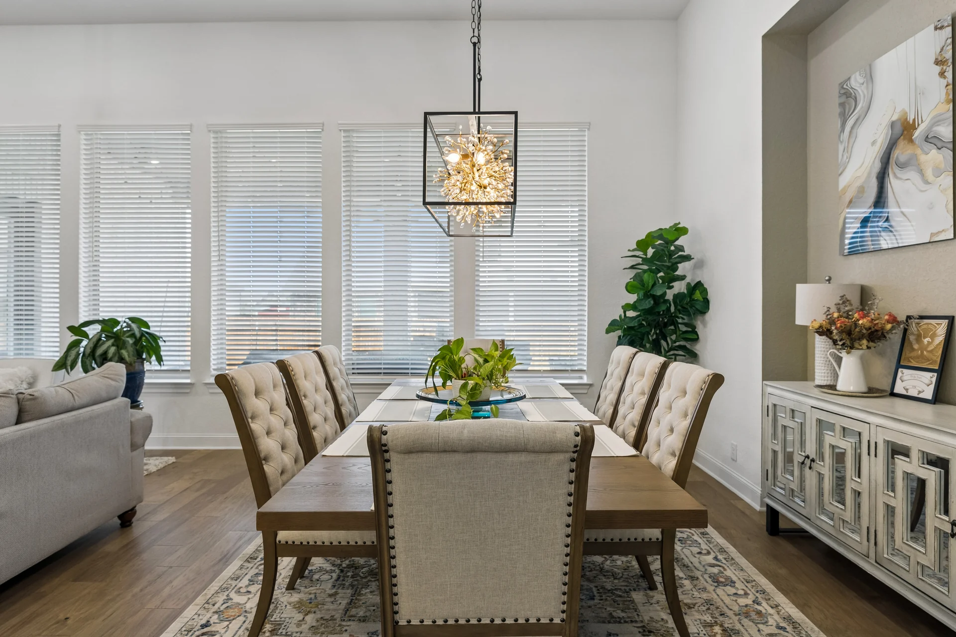 Dining table beneath the rectangular chandelier