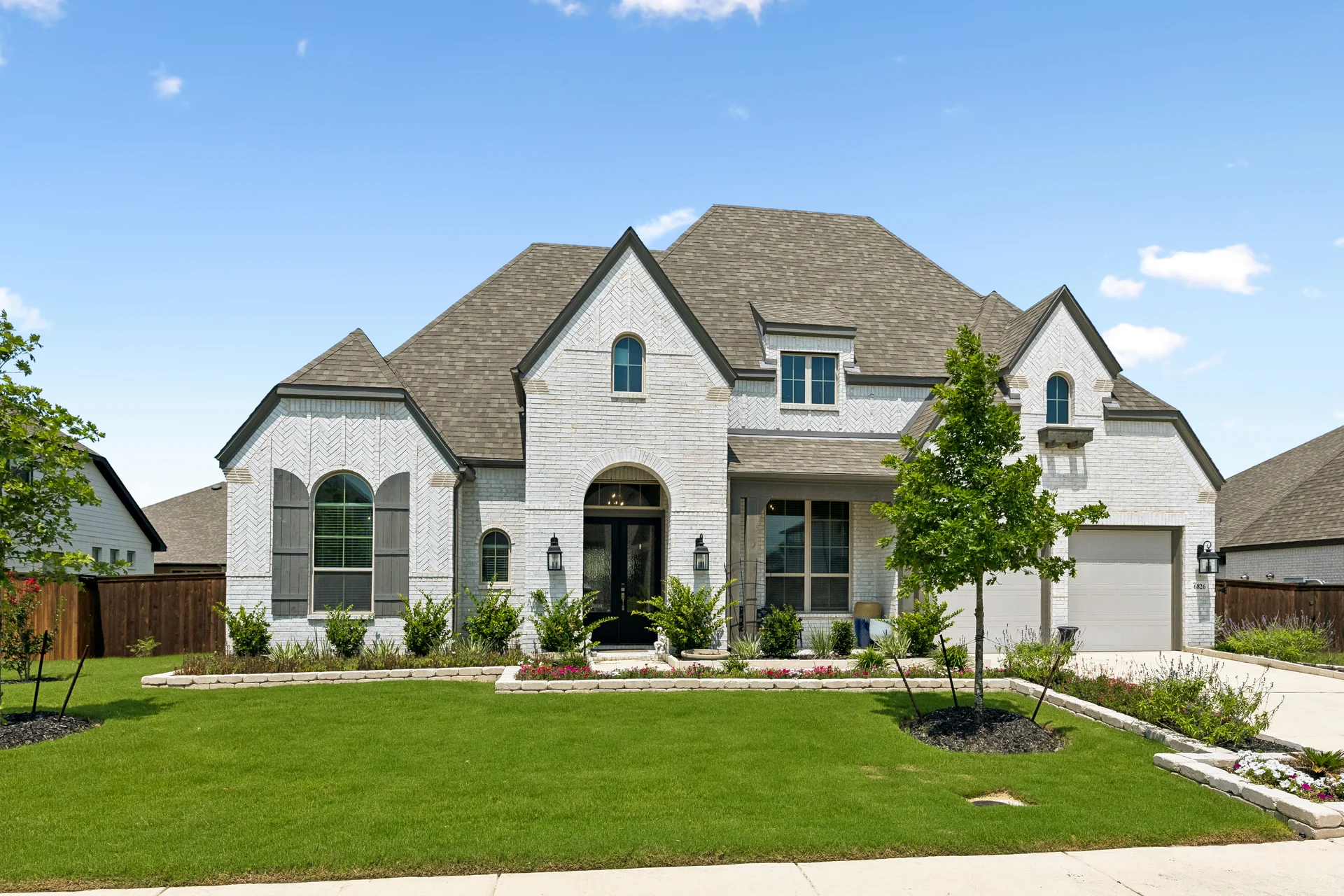 White-brick exterior and arched entry at 6826 Hallie Loop in Schertz