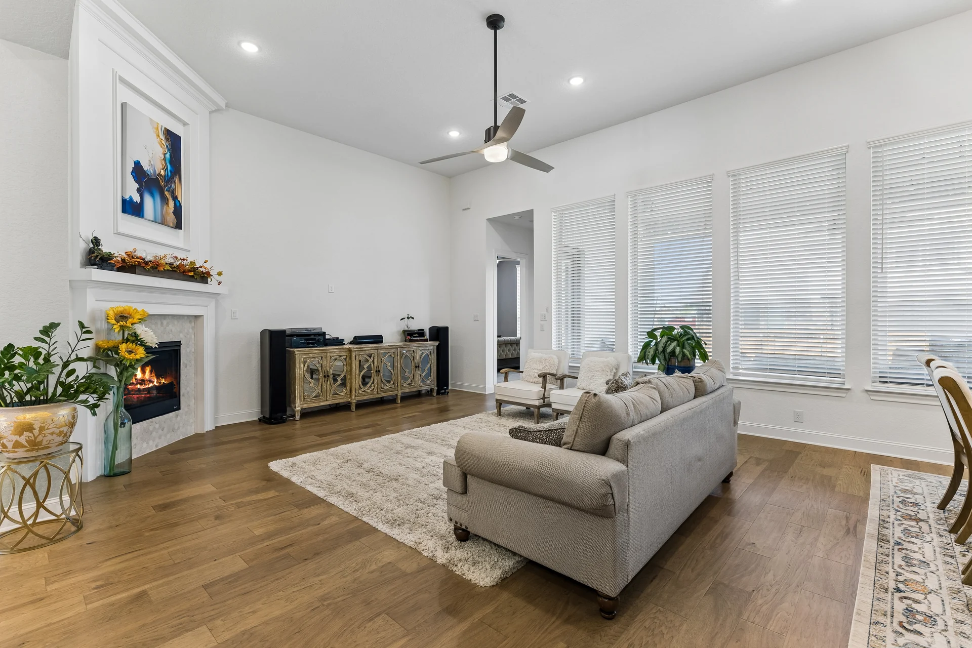 Furnished living room with tall windows and wood flooring