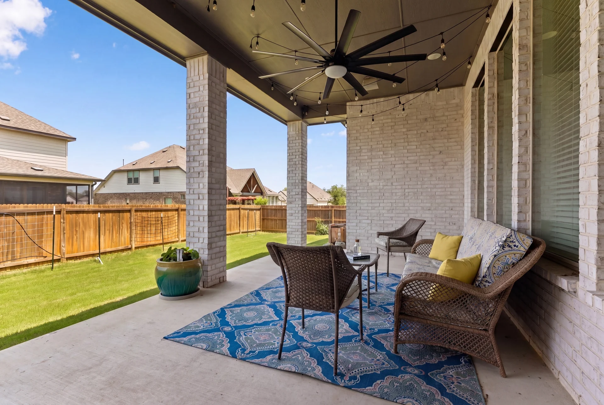 Covered patio opening to the fenced lawn